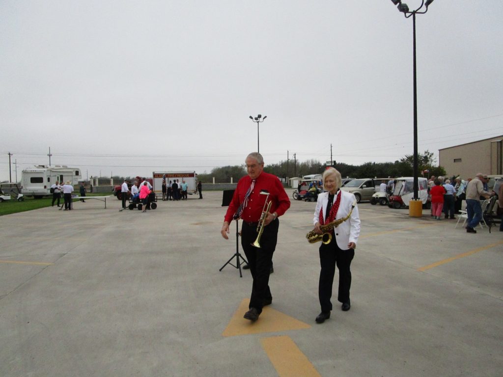 Dr. Chipchase and Mrs. Chipchase carry their instruments after playing for the flag retirement ceremony